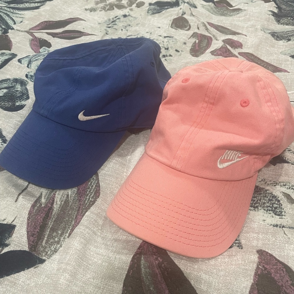 Women’s Nike baseball hats, blue and pink